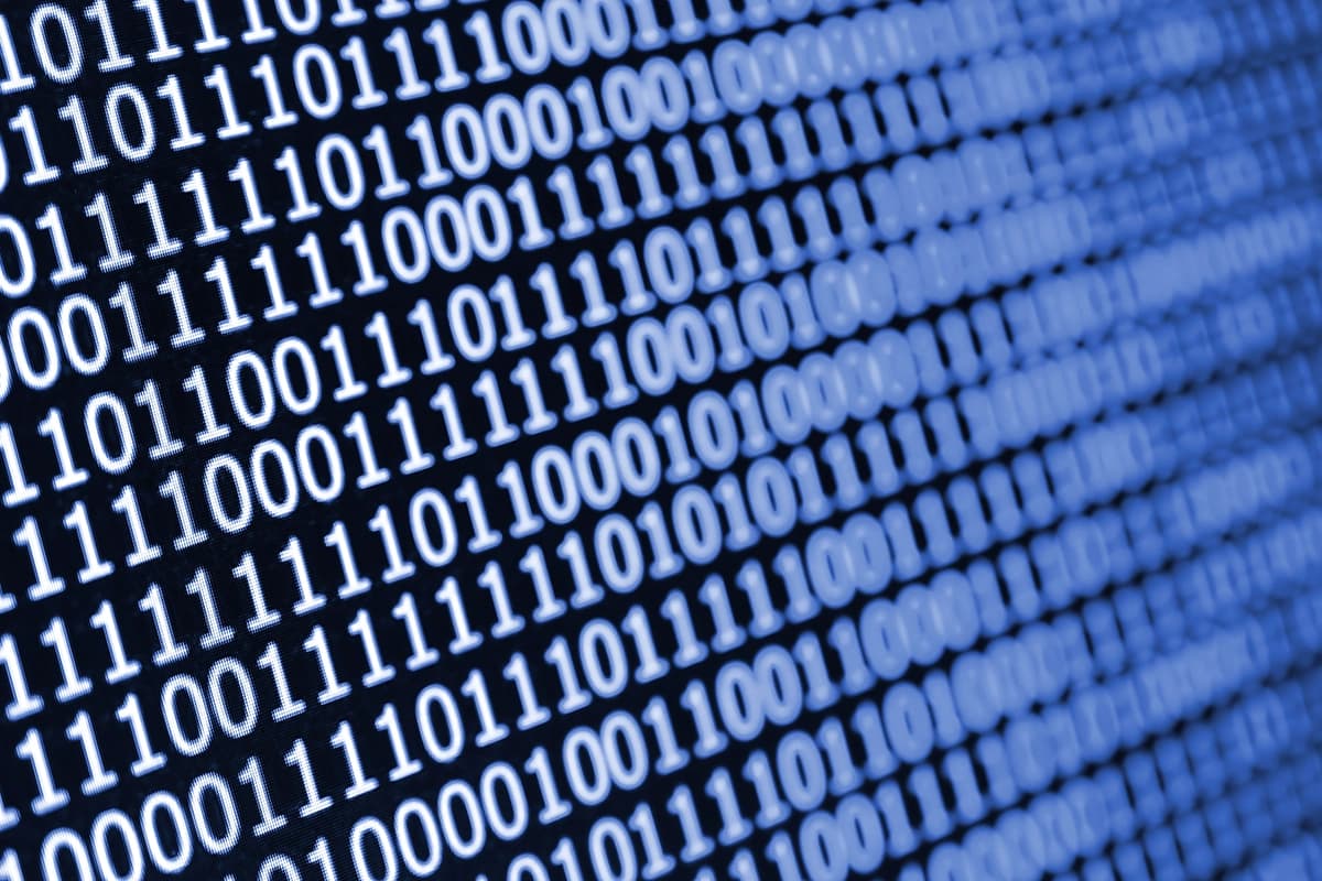 Macro shot of binary code on the monitor of an office