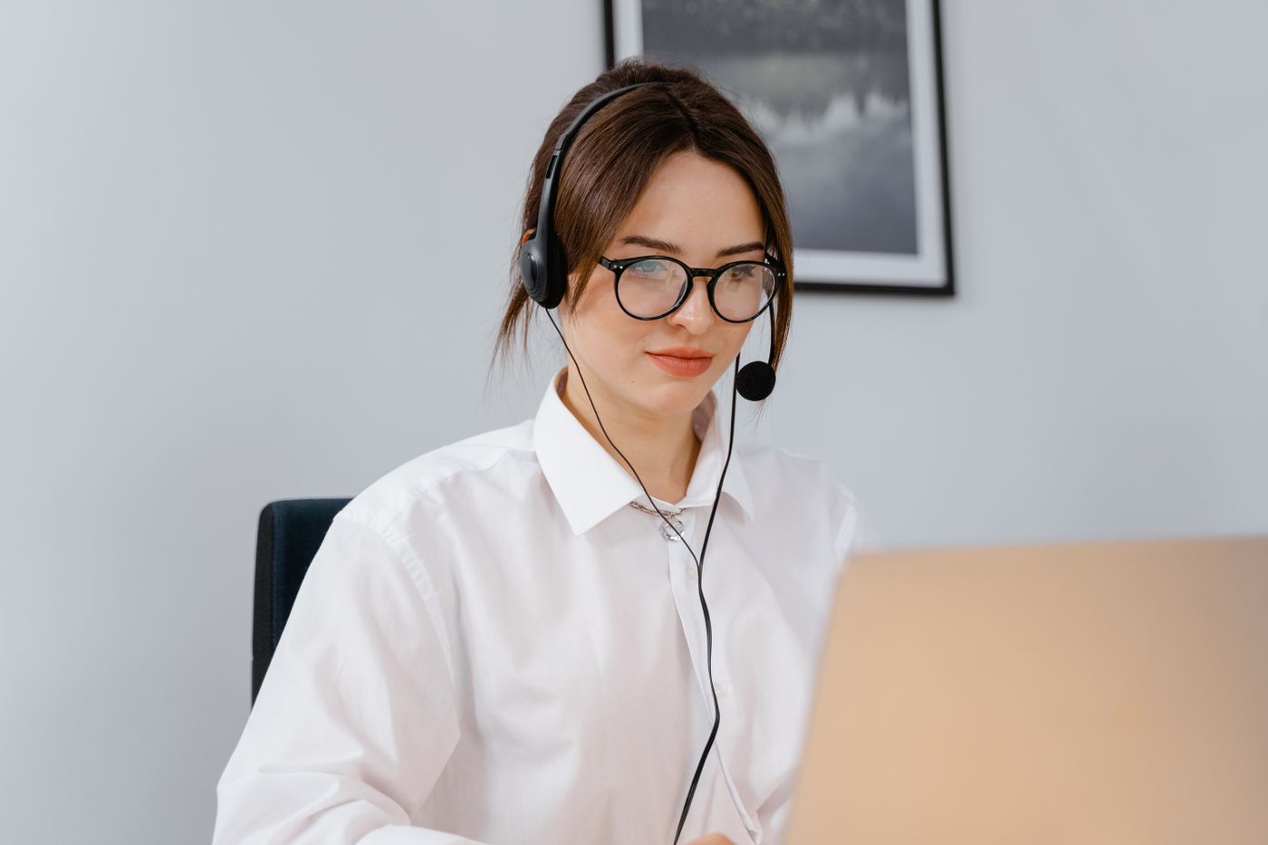 A support professional talking with a customer through a headset