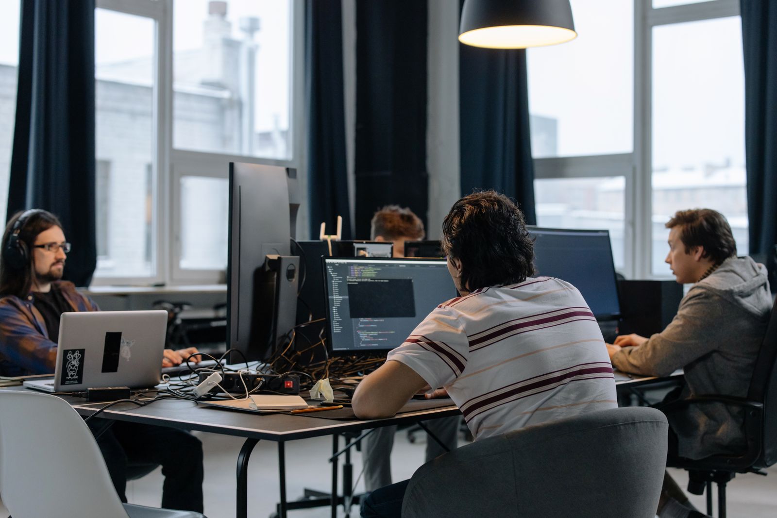 Colleagues working together at computer workstations in a shared office